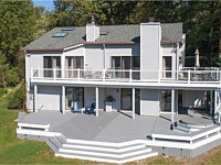 <b>Trex Select Pebble Gray composite decking, white vinyl railing, gray round aluminum balusters, white fascia and vertical skirting</b>